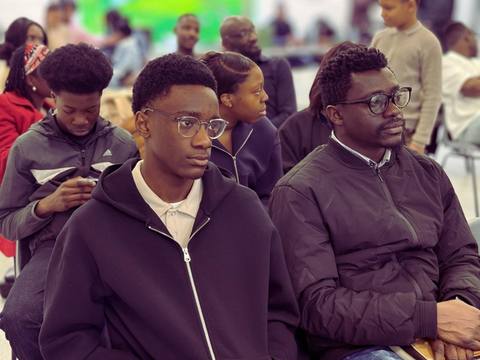 Young men seated together at a service