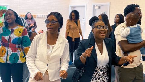 Members singing together during a Sunday service