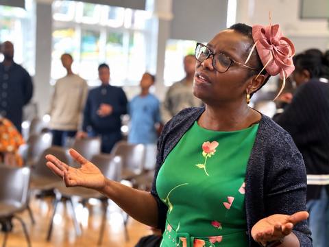 A woman worshipping with her hands open