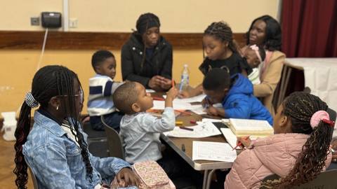 Children and helpers around a table at Children Church