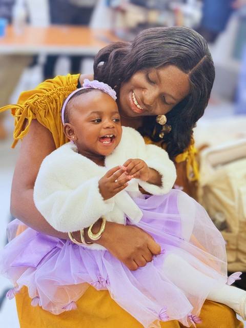A mother holding her smiling baby at church